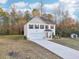 Beautiful two-story home featuring a manicured lawn, extended driveway, and a small storage shed at 382 Daffodil Dr, Temple, GA 30179