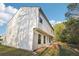 Side view showing the siding and windows of the house, with lush trees in the background at 382 Daffodil Dr, Temple, GA 30179