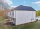 Exterior angle showcasing home's siding, roof, and backyard with green lawn and an AC unit at 382 Daffodil Dr, Temple, GA 30179