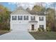 Charming two-story home with a two-car garage and beautifully manicured front yard at 382 Daffodil Dr, Temple, GA 30179