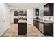 Modern kitchen features granite countertops, stainless steel appliances and an island with dark cabinets at 382 Daffodil Dr, Temple, GA 30179