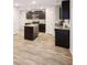 Modern kitchen features granite countertops, stainless steel appliances and an island with dark cabinets at 382 Daffodil Dr, Temple, GA 30179