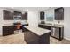Modern kitchen features granite countertops, stainless steel appliances and an island with dark cabinets at 382 Daffodil Dr, Temple, GA 30179
