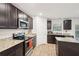 Modern kitchen features granite countertops, stainless steel appliances and an island with dark cabinets at 382 Daffodil Dr, Temple, GA 30179