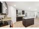 Modern kitchen features granite countertops, stainless steel appliances and an island with dark cabinets at 382 Daffodil Dr, Temple, GA 30179
