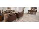 Inviting living room with leather furnishings, neutral walls, and open access to the kitchen and dining area at 382 Daffodil Dr, Temple, GA 30179