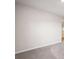 A spacious carpeted living room space with neutral paint and a smooth wall surface at 382 Daffodil Dr, Temple, GA 30179