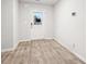 Bright room featuring a door with window and modern hardwood flooring, ideal as a foyer or bonus space at 382 Daffodil Dr, Temple, GA 30179