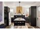 Stylish kitchen with stainless steel appliances, island with a white countertop and sleek black cabinets at 11572 Serenbe Ln, Chattahoochee Hills, GA 30268