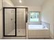 Modern bathroom with tiled shower and a garden soaking tub at 121 Honey Creek Rd, Conyers, GA 30094