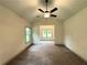 Bright and airy bedroom featuring plush carpet, a vaulted ceiling, and a ceiling fan at 121 Honey Creek Rd, Conyers, GA 30094