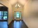 Bright foyer with high ceilings, dark hardwood floors, and a modern chandelier fixture at 121 Honey Creek Rd, Conyers, GA 30094