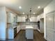 Modern kitchen with white cabinets, granite countertops, stainless steel appliances, and a center island at 121 Honey Creek Rd, Conyers, GA 30094