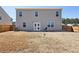 A view of the back of the property with well-kept lawn, a patio, and privacy fencing at 201 Cranapple Ln, Mcdonough, GA 30253