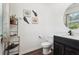 Charming half-bath featuring a dark wood vanity and stylish wall decor, complete with wood-look flooring at 201 Cranapple Ln, Mcdonough, GA 30253