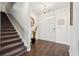 Stylish foyer with hardwood floors, staircase, and modern decor with lots of natural light at 201 Cranapple Ln, Mcdonough, GA 30253