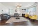 Bright living room with hardwood floors, fireplace, neutral walls, stylish seating, and elegant decor at 201 Cranapple Ln, Mcdonough, GA 30253