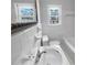 Bright bathroom featuring a classic white sink, a bathtub, and tiled walls, all bathed in natural light at 233 Bay Creek Rd, Loganville, GA 30052