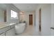 Bathroom featuring a freestanding tub, double vanity with white countertops, and marble flooring at 400 Hatcher Ct, Hampton, GA 30228