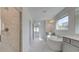 Bathroom featuring a glass-enclosed shower, freestanding tub, and double vanity with white countertops at 400 Hatcher Ct, Hampton, GA 30228