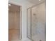 Bathroom with a glass-enclosed shower featuring marble-style tiling at 400 Hatcher Ct, Hampton, GA 30228