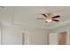 Bedroom featuring a ceiling fan, tray ceiling, and white trim at 400 Hatcher Ct, Hampton, GA 30228