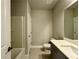 Neutral bathroom featuring a shower-tub combination, white toilet, vanity with white countertop and grey cabinetry at 123 Honey Creek Rd, Conyers, GA 30094