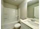 Bright bathroom with a shower-tub, and quartz countertop vanity at 123 Honey Creek Rd, Conyers, GA 30094