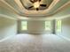 Spacious bedroom featuring a trey ceiling, ceiling fan, and multiple windows at 123 Honey Creek Rd, Conyers, GA 30094