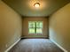 Comfortable bedroom with soft carpeting and a large window at 123 Honey Creek Rd, Conyers, GA 30094