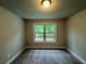 Bedroom featuring carpeted floors and a double-paned window that brings in plenty of natural light at 123 Honey Creek Rd, Conyers, GA 30094