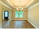 Elegant dining room with hardwood floors, tray ceiling, and chandelier at 123 Honey Creek Rd, Conyers, GA 30094