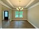 Elegant dining room featuring wood floors, crown molding, and a stylish chandelier at 123 Honey Creek Rd, Conyers, GA 30094