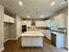 Modern kitchen with an island, stainless steel appliances, and patterned backsplash at 123 Honey Creek Rd, Conyers, GA 30094