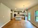 Open-concept kitchen with white cabinetry, stainless steel appliances, and hardwood floors at 123 Honey Creek Rd, Conyers, GA 30094