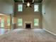 Spacious living room with a fireplace, high ceilings, and large windows at 123 Honey Creek Rd, Conyers, GA 30094