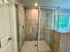 Modern tiled shower featuring a glass door and shower head at 123 Honey Creek Rd, Conyers, GA 30094