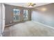 Empty bedroom with carpet, neutral gray walls, and two windows at 165 N River Dr # G, Atlanta, GA 30350