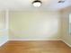 Empty living room featuring hardwood floors with large blank walls and trim at 165 N River Dr # G, Atlanta, GA 30350