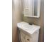 Bathroom with a single sink vanity featuring a white cabinet and mirror at 2179 Powers Ferry Dr, Marietta, GA 30067