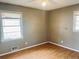 Cozy bedroom featuring a bright window, ceiling fan, and hardwood floors at 2179 Powers Ferry Dr, Marietta, GA 30067