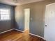 Bedroom with hardwood floors and neutral gray walls, with doors to closet and hall at 2179 Powers Ferry Dr, Marietta, GA 30067