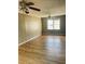 Spacious bedroom featuring hardwood floors, ceiling fans, neutral paint, and ample natural light at 2179 Powers Ferry Dr, Marietta, GA 30067