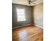 Bedroom with hardwood floors, fan, and a bright window overlooking the yard at 2179 Powers Ferry Dr, Marietta, GA 30067