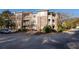 Apartment building with brick facade, balconies, manicured landscaping, and ample parking at 2700 Pine Tree Ne Rd # 1211, Atlanta, GA 30324