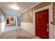 Well-lit hallway leading to a red door and staircase at 2700 Pine Tree Ne Rd # 1211, Atlanta, GA 30324