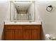 A full bathroom features a double sink vanity, a mirror, and a shower at 5338 Creekview Ln, Morrow, GA 30260