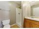 A bathroom featuring a vanity with sink, toilet, and walk-in shower at 5338 Creekview Ln, Morrow, GA 30260