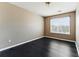 A bedroom featuring a window for natural light and dark wood-look flooring at 5338 Creekview Ln, Morrow, GA 30260