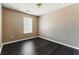 A bedroom featuring a window for natural light and dark wood-look flooring at 5338 Creekview Ln, Morrow, GA 30260